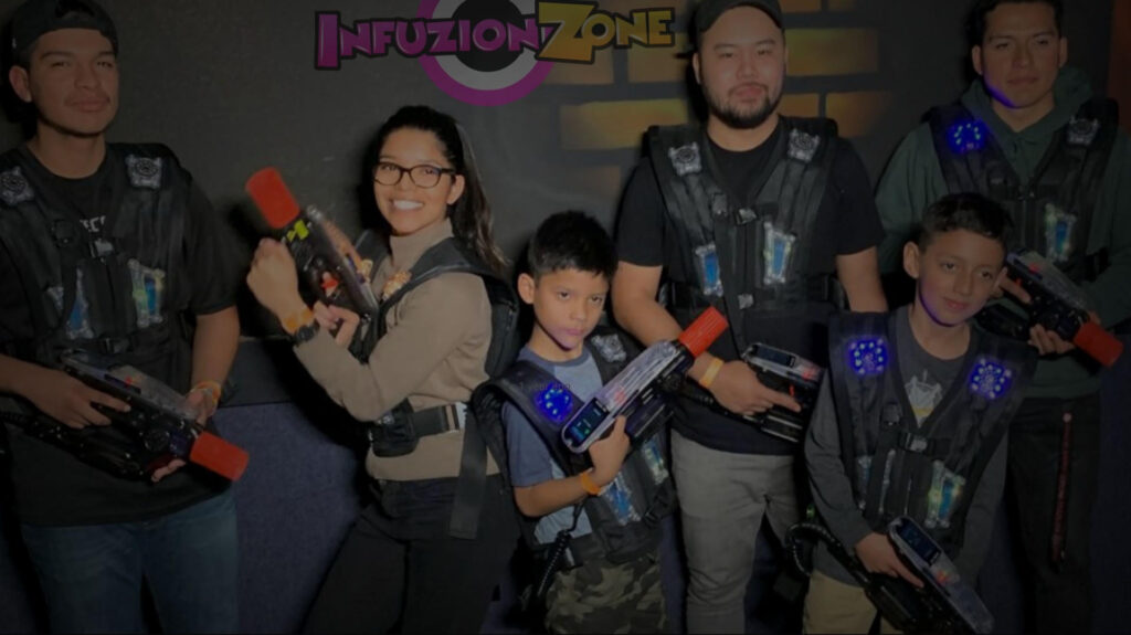 Smiling group wearing vests playing laser tag